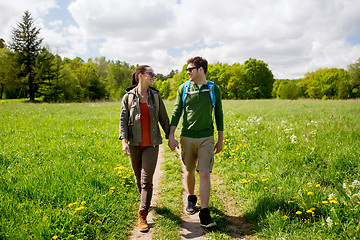 Image showing happy couple with backpacks hiking outdoors