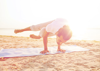 Image showing man doing yoga exercises outdoors