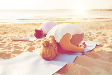 Image showing close up of couple making yoga exercises outdoors