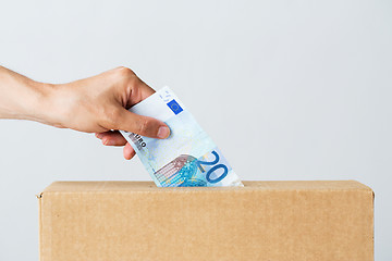 Image showing man putting euro money into donation box