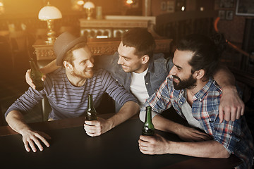 Image showing happy male friends drinking beer at bar or pub