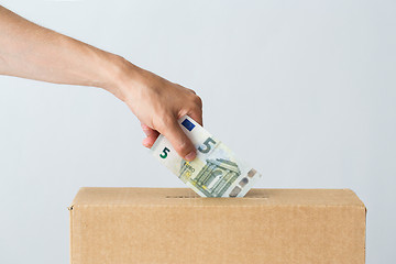 Image showing man putting euro money into donation box