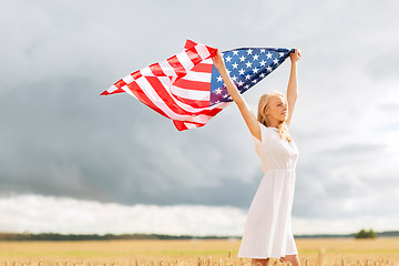 Image showing happy woman with american flag on cereal field