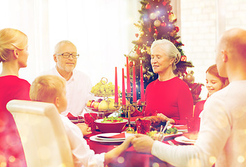 Image showing smiling family having holiday dinner at home