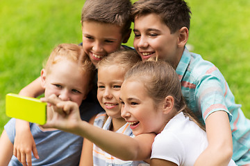 Image showing happy kids or friends taking selfie in summer park