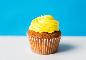 Image showing close up of cupcake or muffin with icing on table