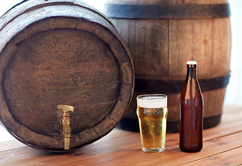 Image showing close up of old beer barrel, glass and bottle