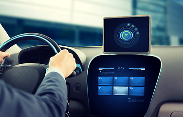 Image showing close up of man with tablet pc driving car