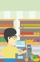 Image showing Cashier standing at the checkout in supermarket.