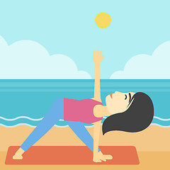 Image showing Woman practicing yoga triangle pose on the beach.