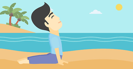 Image showing Man practicing yoga upward dog pose on the beach.