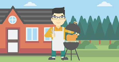 Image showing Man cooking chicken on barbecue grill.