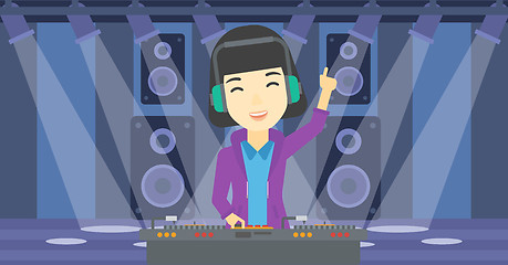 Image showing Smiling DJ mixing music on turntables.