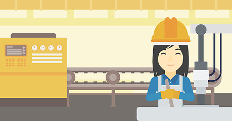 Image showing Woman working on industrial drilling machine.