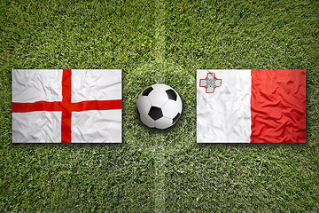 Image showing England and Malta flags on soccer field