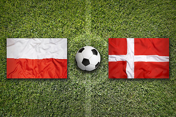 Image showing Poland and Denmark flags on soccer field
