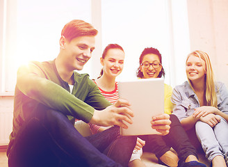 Image showing smiling students making picture with tablet pc