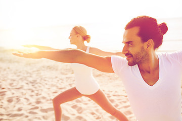 Image showing close up of couple making yoga exercises outdoors