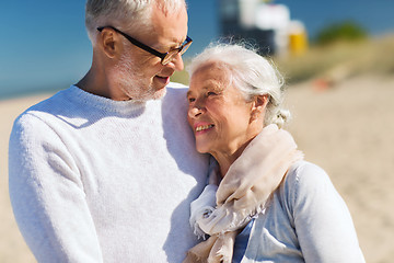 Image showing happy senior couple hugging on summer beach