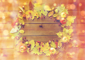 Image showing set of autumn leaves, fruits and berries on wood