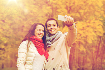 Image showing smiling couple hugging in autumn park