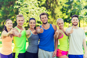 Image showing group of happy sporty friends showing thumbs up