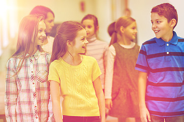 Image showing group of smiling school kids walking in corridor