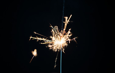 Image showing sparkler burning over black background