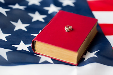 Image showing close up of american flag, wedding rings and bible