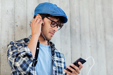 Image showing man with earphones and smartphone listening music