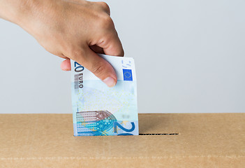 Image showing man putting euro money into donation box