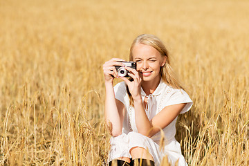 Image showing happy woman with film camera in wreath of flowers