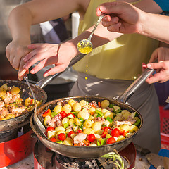 Image showing Cheff cooking traditional Mediterranean octopus on street stall.