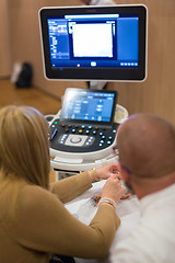 Image showing Medical doctor student learning to use ultra sound scanner machine.
