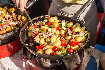 Image showing Cheff cooking traditional Mediterranean octopus on street stall.