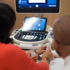 Image showing Medical doctor student learning to use ultra sound scanner machine.