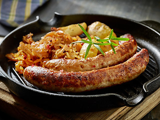 Image showing grilled sausages and vegetables on cooking pan