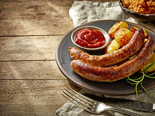 Image showing grilled sausages on dark plate