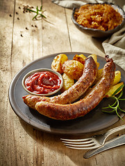 Image showing grilled sausages on dark plate