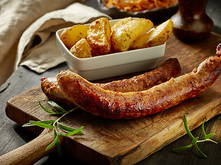 Image showing grilled sausages and potatoes