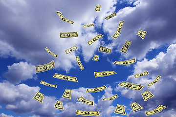 Image showing dollar banknotes flying away in the sky