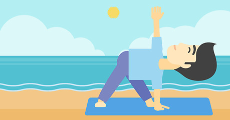 Image showing Man practicing yoga triangle pose on the beach.