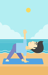 Image showing Man practicing yoga triangle pose on the beach.