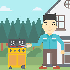 Image showing Man cooking meat on gas barbecue grill.