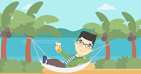 Image showing Man chilling in hammock with cocktail.