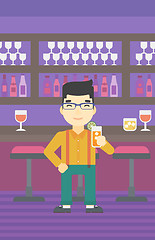 Image showing Man drinking orange cocktail at the bar.