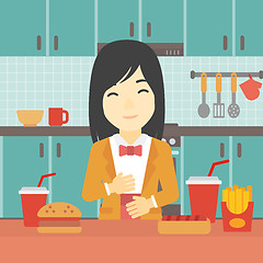 Image showing Satisfied woman eating fast food.