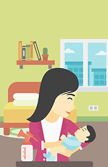 Image showing Mother with baby and breast pump.