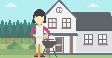 Image showing Woman cooking meat on barbecue grill.