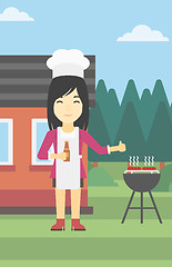 Image showing Woman cooking meat on gas barbecue grill.